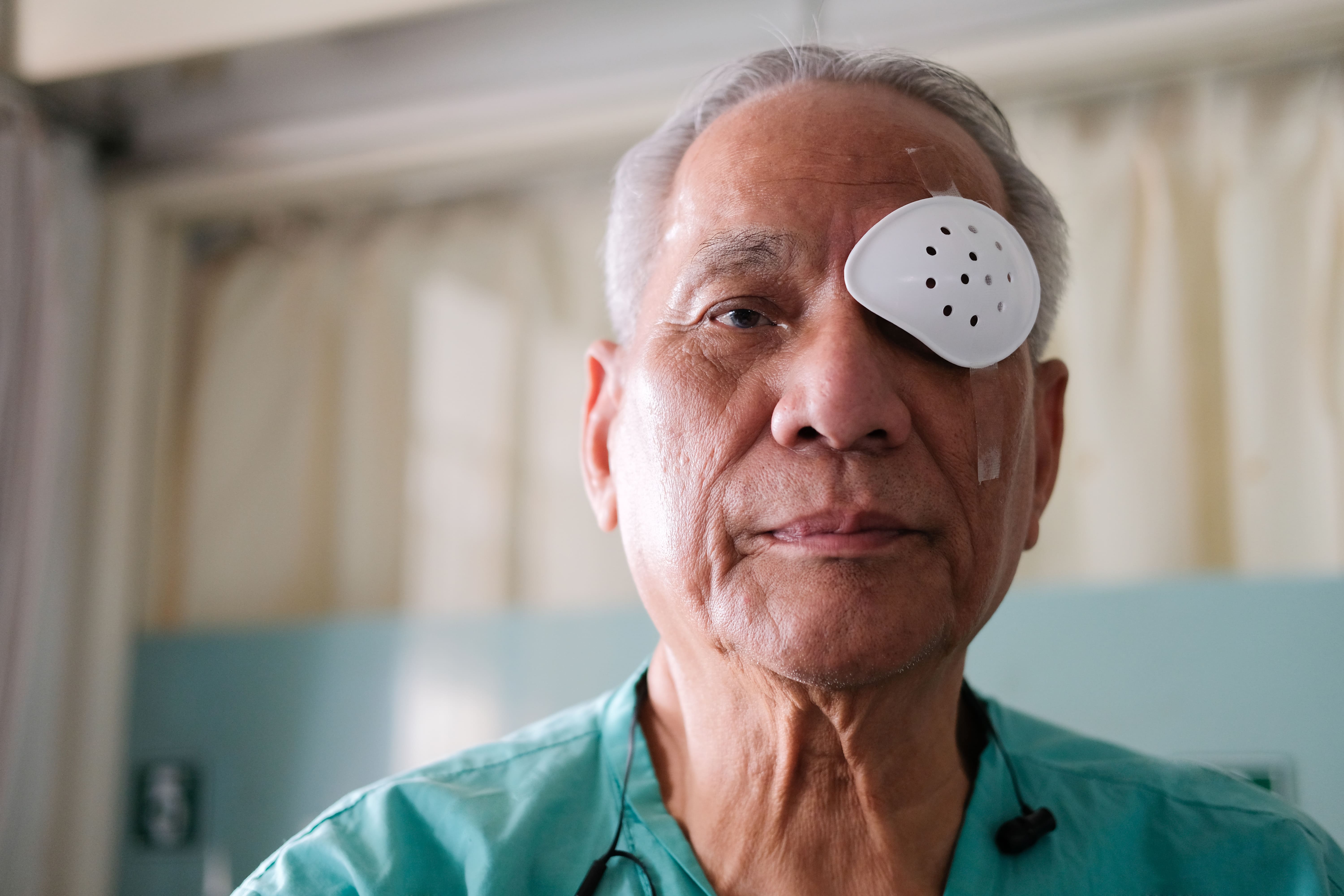 Elderly patient wearing an eye patch after cataract surgery, illustrating the typical recovery period following cataract treatment.